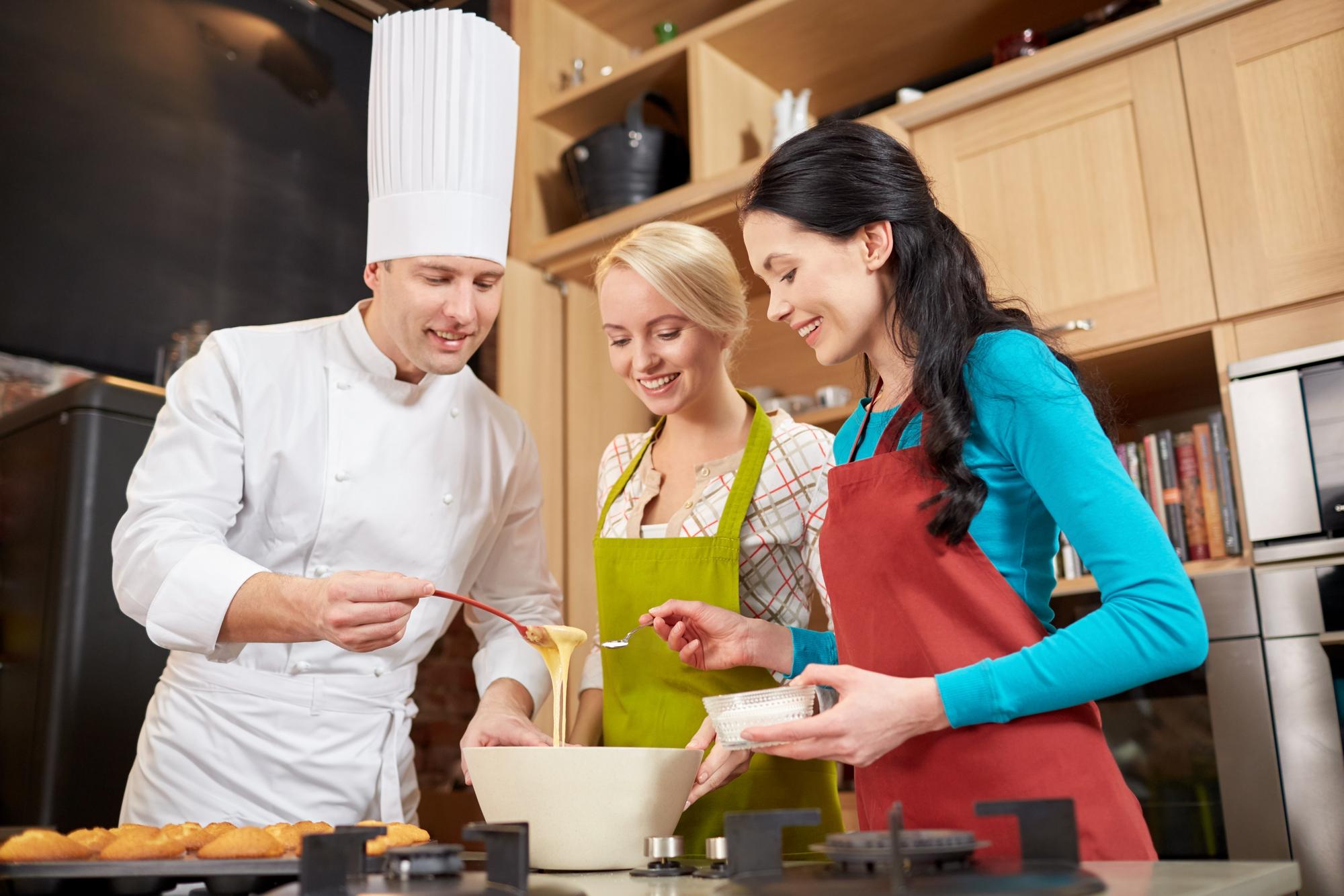 Chef teaching in a warm kitchen with floating panels